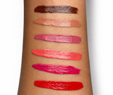 Lipstick swatches on a person's arm with a white background